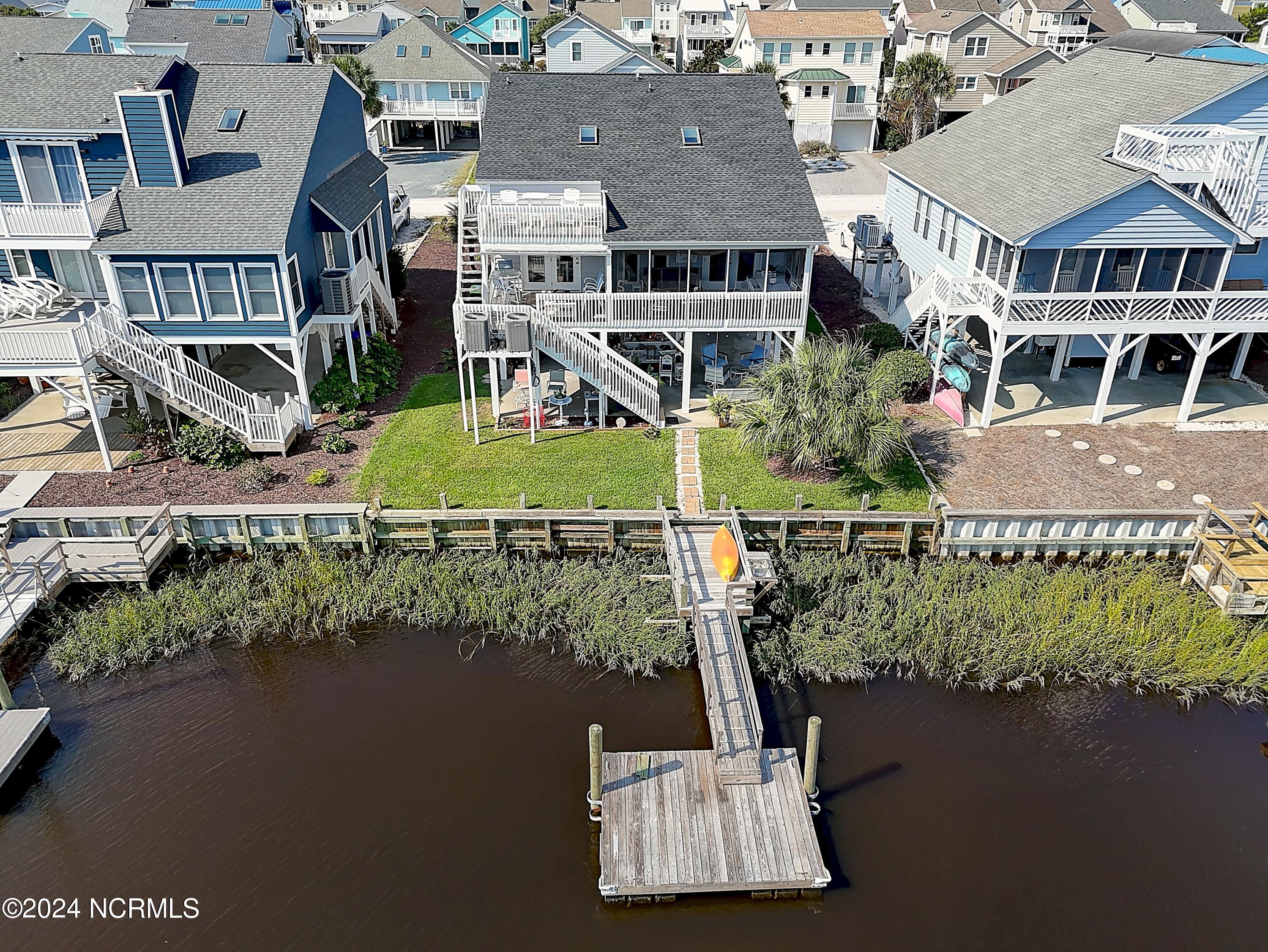 415 Sailfish Street Sunset Beach, NC 28468 - Photo 4 of 63 Located on an east facing canal lot with pier and floating dock.