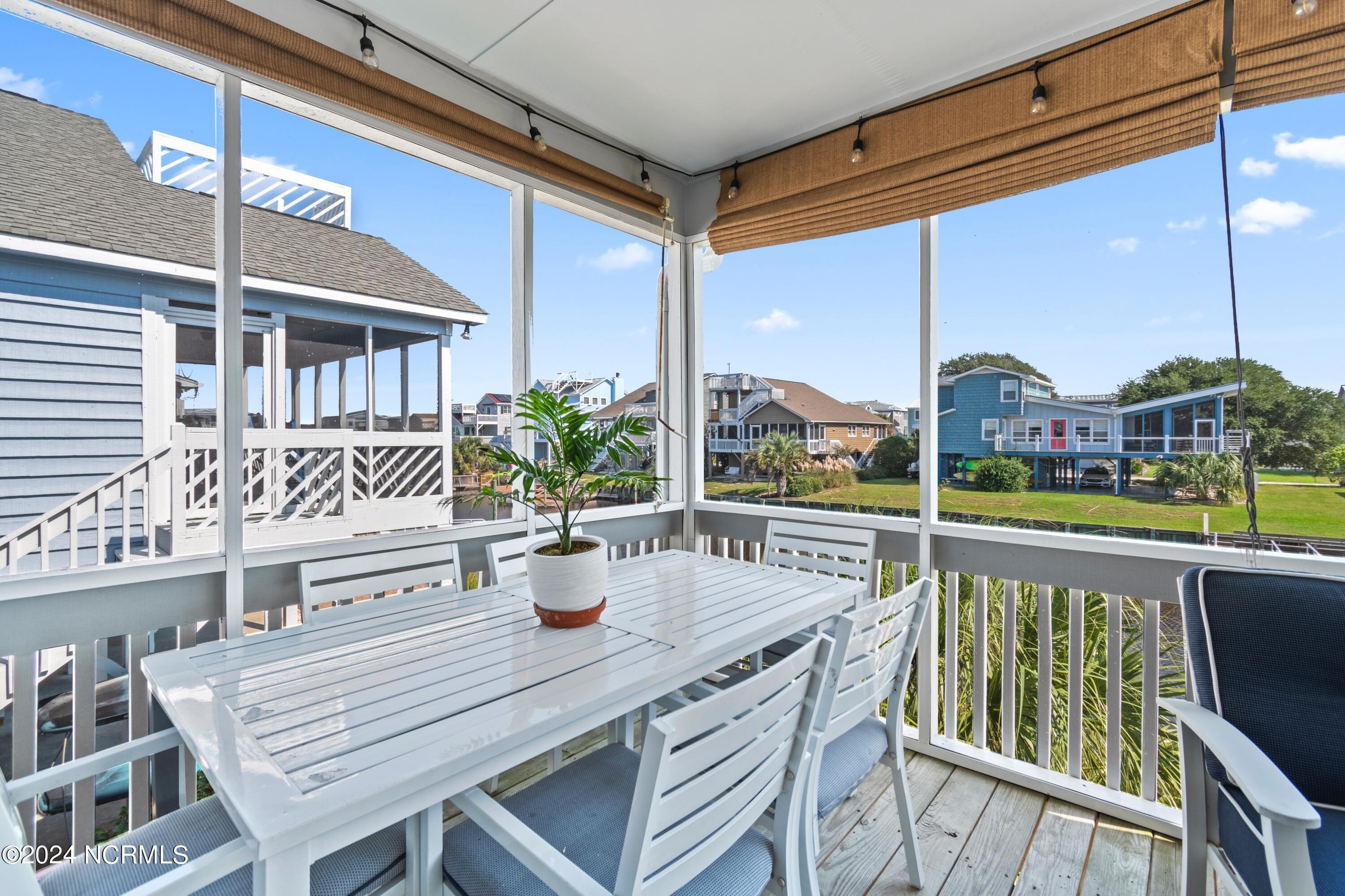 415 Sailfish Street Sunset Beach, NC 28468 - Photo 40 of 63 Screened porch allows for year long enjoyment.
