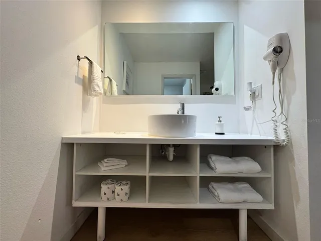 a bathroom with a sink and a mirror