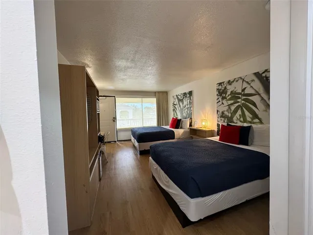 a living room with a bed furniture and a window