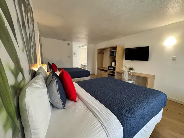a bedroom with a bed and a flat screen tv
