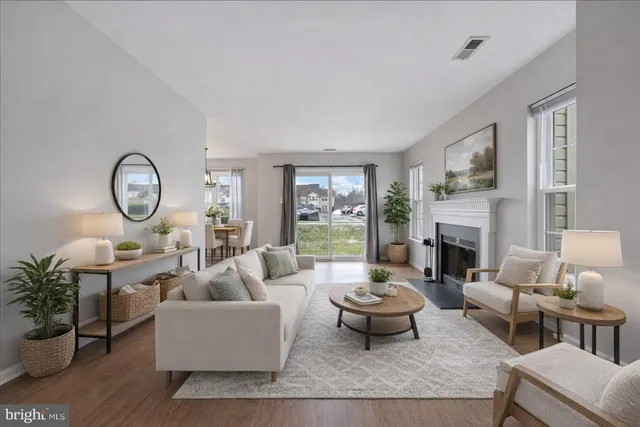 a living room with furniture fireplace and a large window