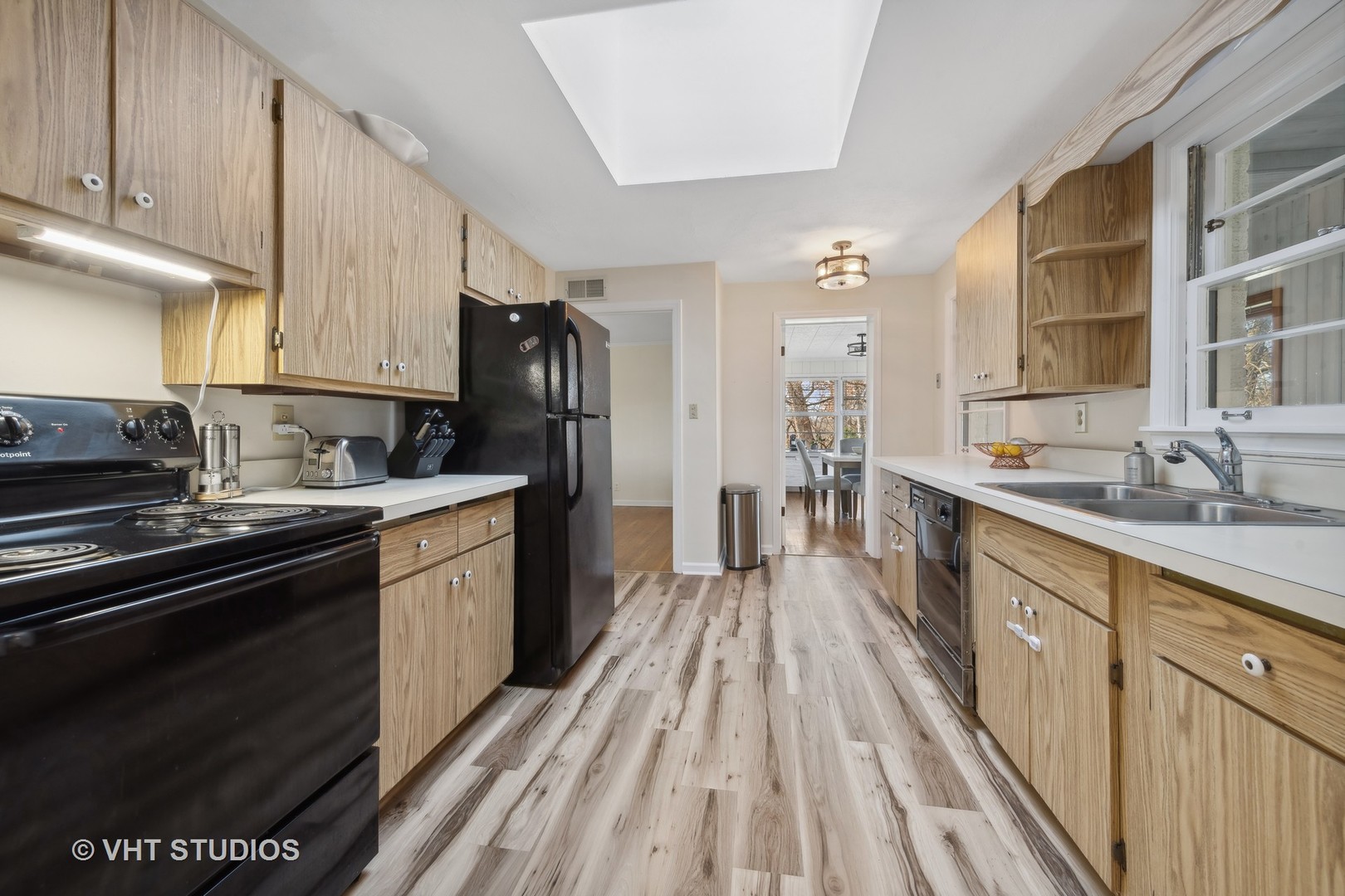 412 Warwick Road Tower Lakes, IL 60010 - Photo 5 of 30 a kitchen with stainless steel appliances granite countertop a refrigerator a sink dishwasher a stove and white countertops with wooden floor