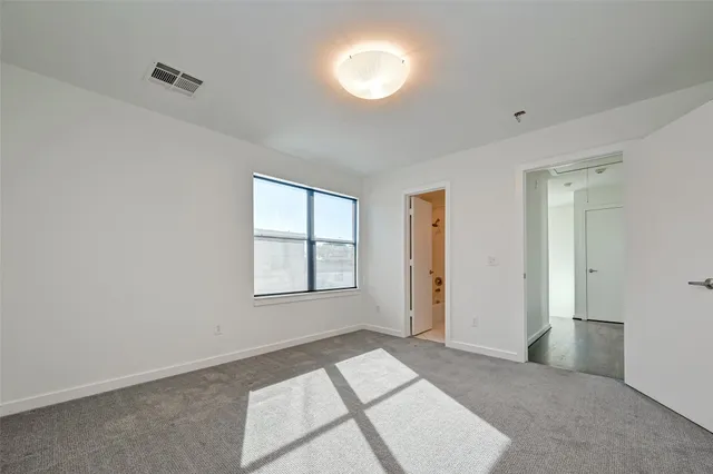 a bathroom with a granite countertop sink a toilet and mirror