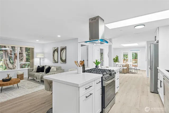 a very nice looking living room with a large window and wooden floor