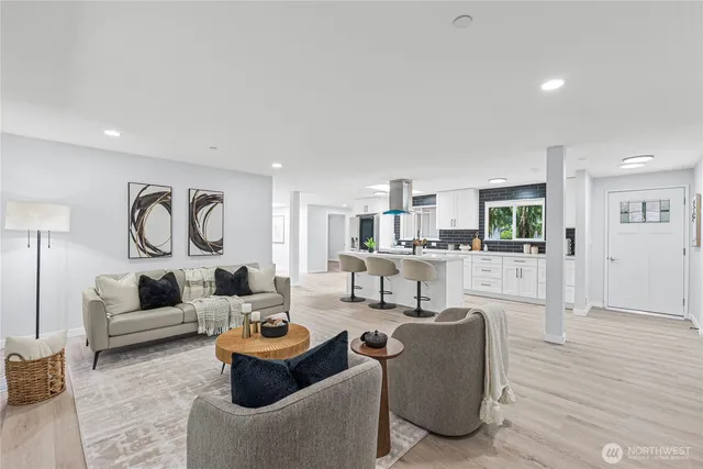 a living room with furniture and a wooden floor