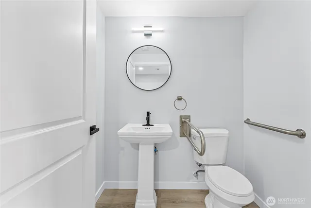 a bathroom with a toilet a sink and a mirror
