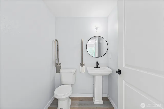 a bathroom with a toilet sink and a mirror
