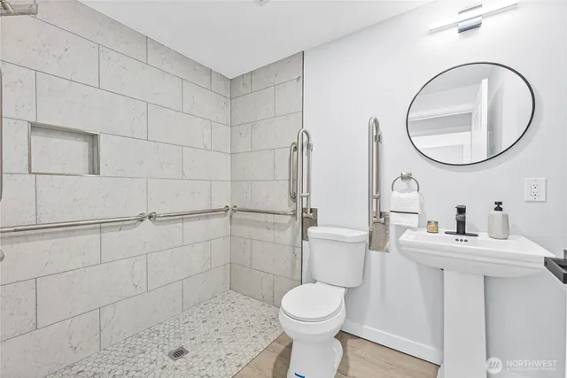 a bathroom with a sink toilet and a mirror