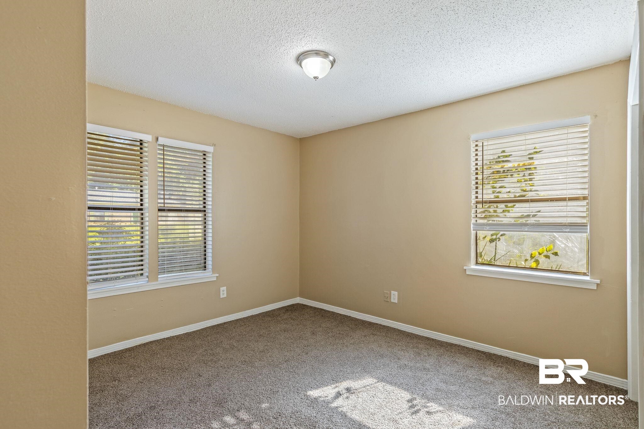 4151 Springdale Road Mobile, AL 36609 - Photo 9 of 21 Carpeted empty room featuring a textured ceiling