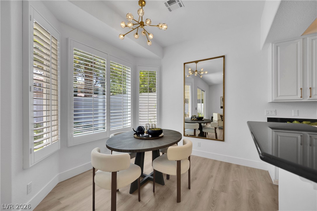 8981 Rivers Edge Drive Las Vegas, NV 89117 - Photo 16 of 69 An inviting dining area offers rich wood flooring and abundant natural light through bright shuttered windows.