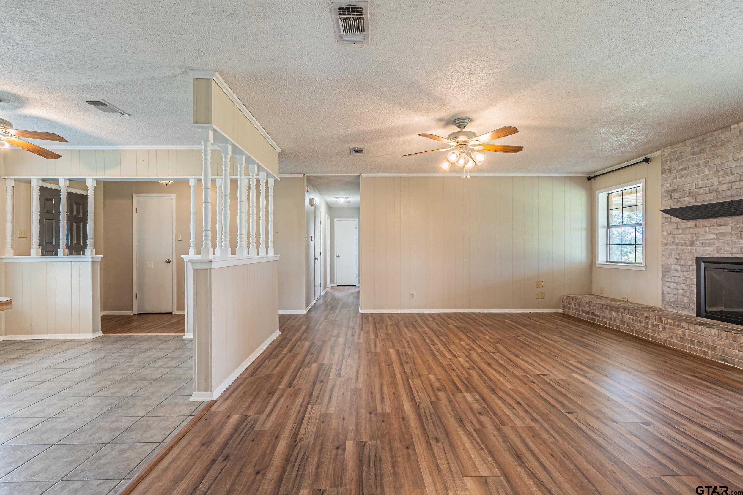 401 VZ County Road Canton, TX 75103 - Photo 17 of 45 a view of an empty room with wooden floor and a ceiling fan
