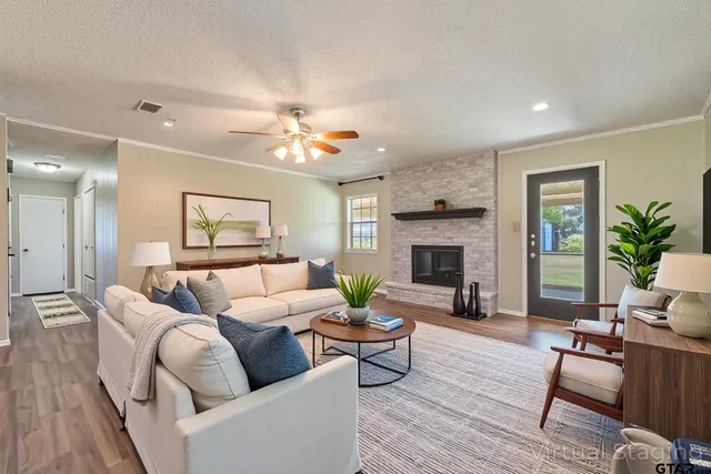a living room with furniture and view of kitchen