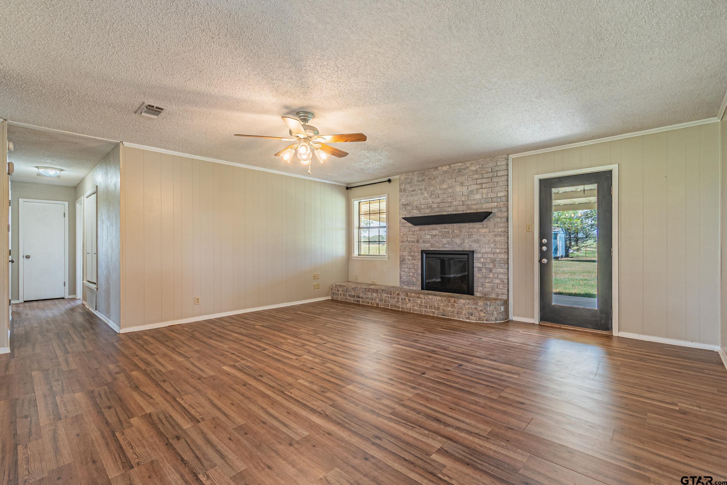 401 VZ County Road Canton, TX 75103 - Photo 19 of 45 a view of an empty room with a fireplace and a window