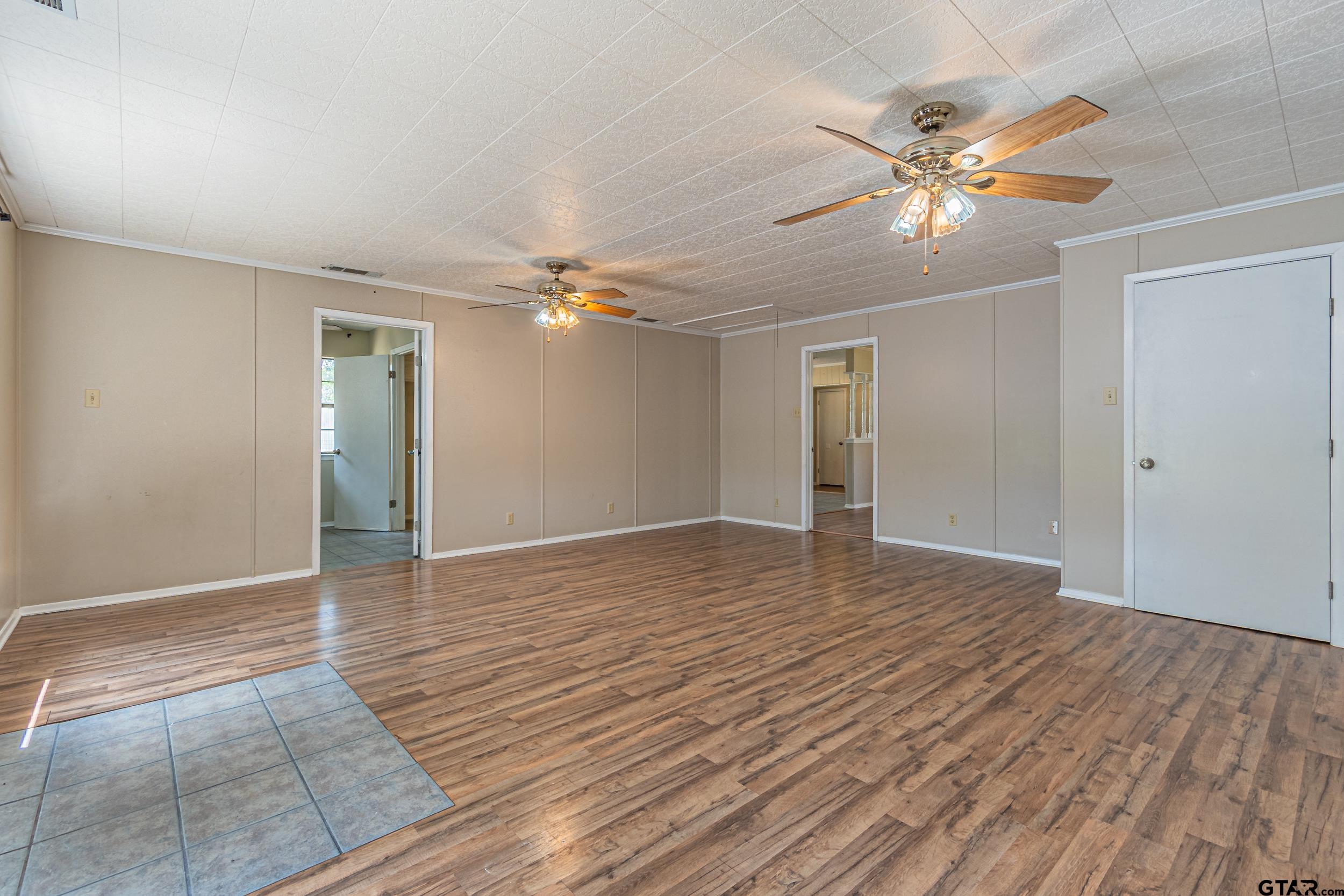 401 VZ County Road Canton, TX 75103 - Photo 23 of 45 a view of an empty room with wooden floor and fan