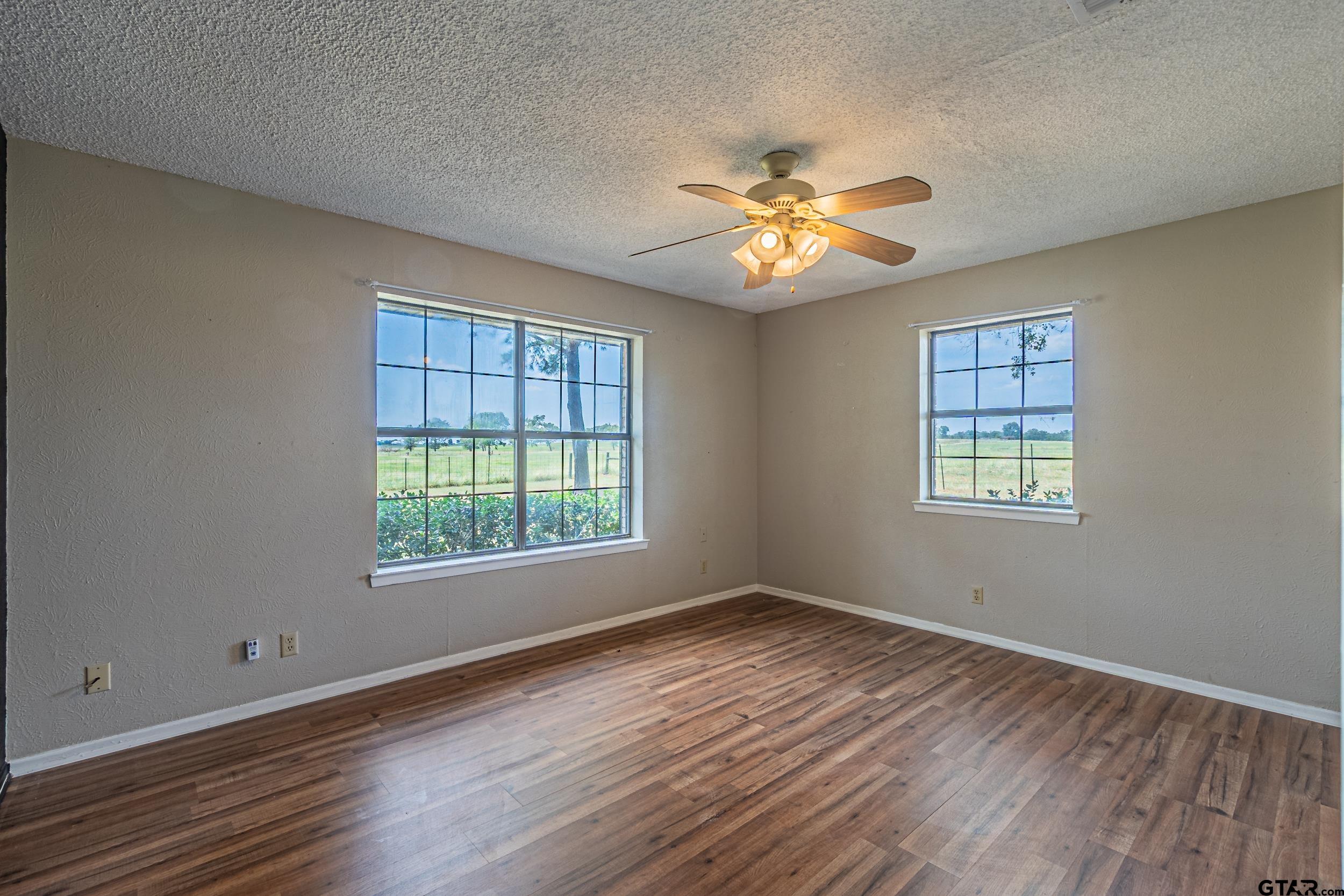 401 VZ County Road Canton, TX 75103 - Photo 30 of 45 a view of empty room with wooden floor and fan