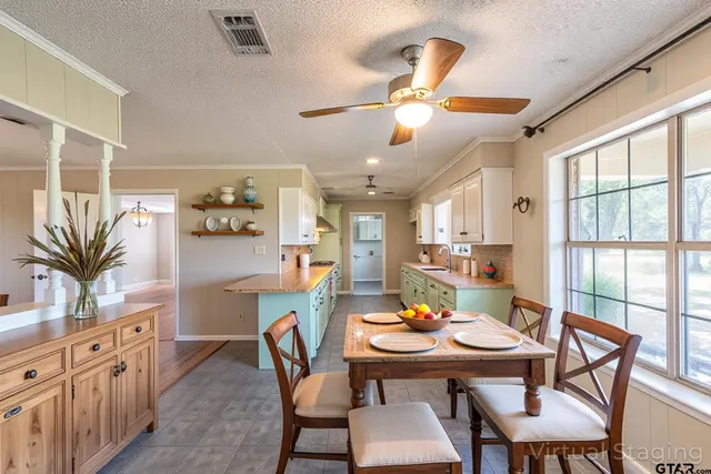 a kitchen with stainless steel appliances a sink and a wooden floor