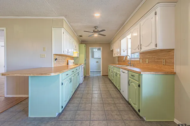 a kitchen with stainless steel appliances granite countertop a sink and cabinets