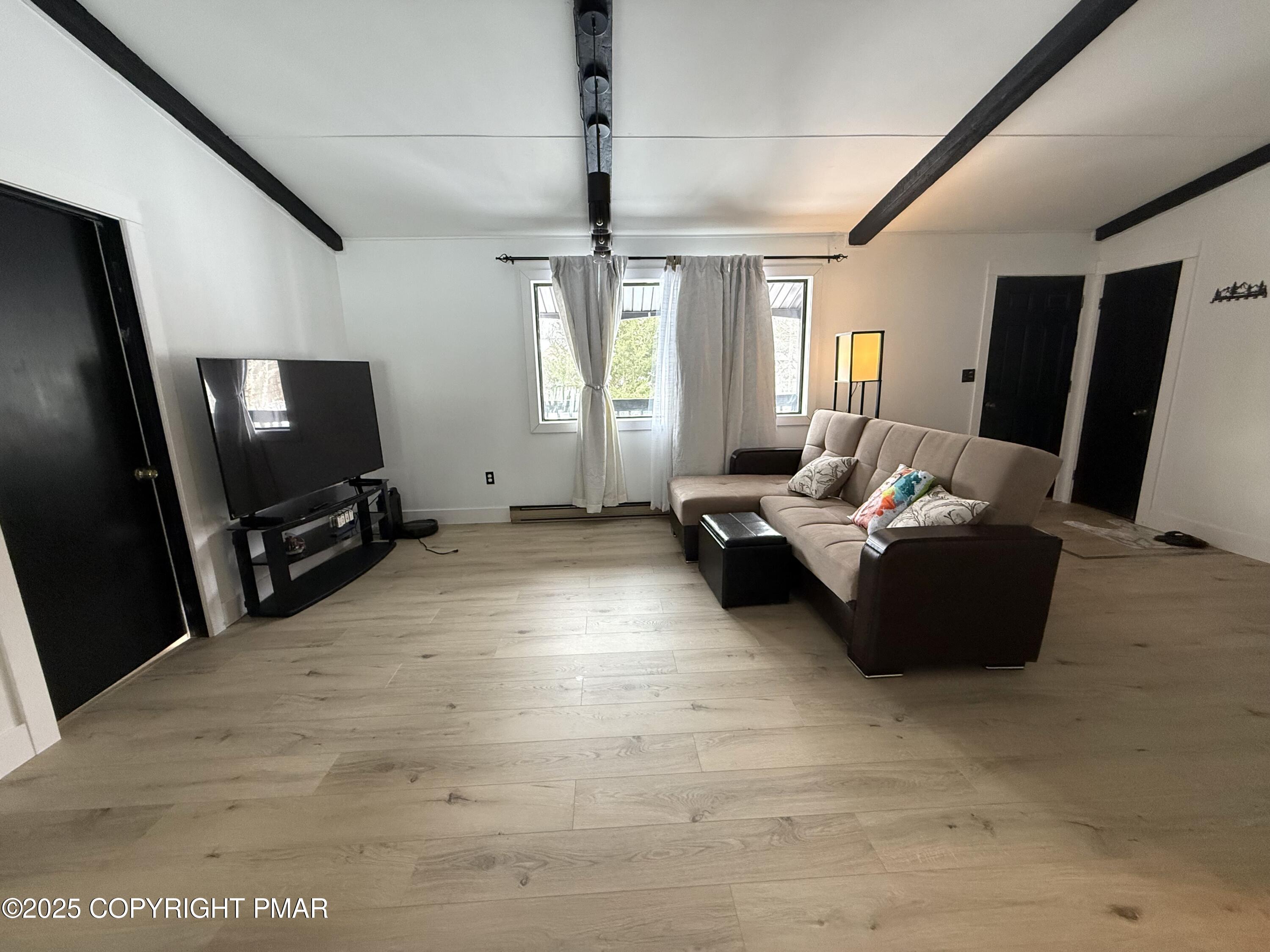 1215 Steele Circle Bushkill, PA 18324 - Photo 5 of 13 a living room with furniture and a flat screen tv
