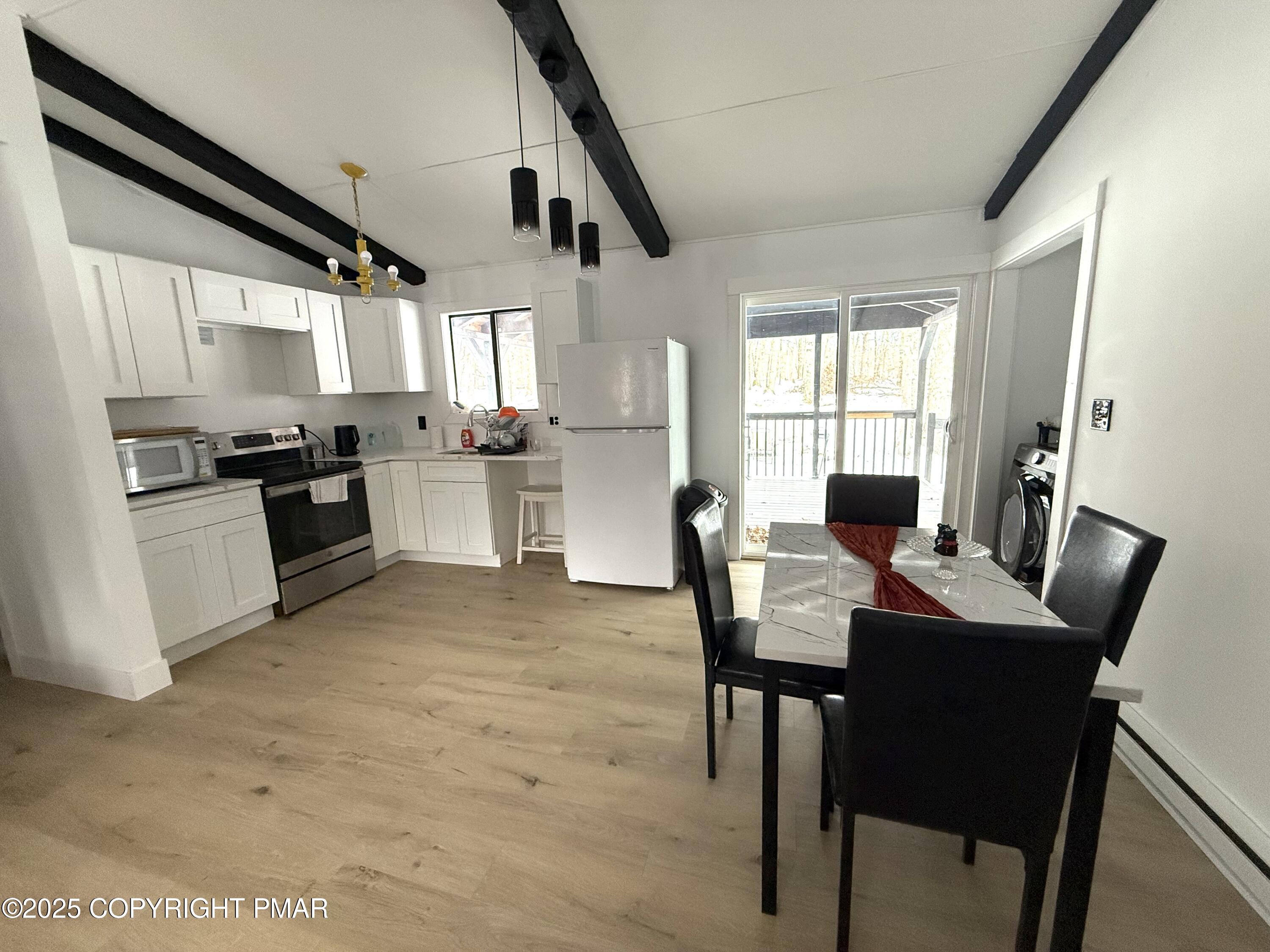 1215 Steele Circle Bushkill, PA 18324 - Photo 6 of 13 a kitchen with a table and chairs in it