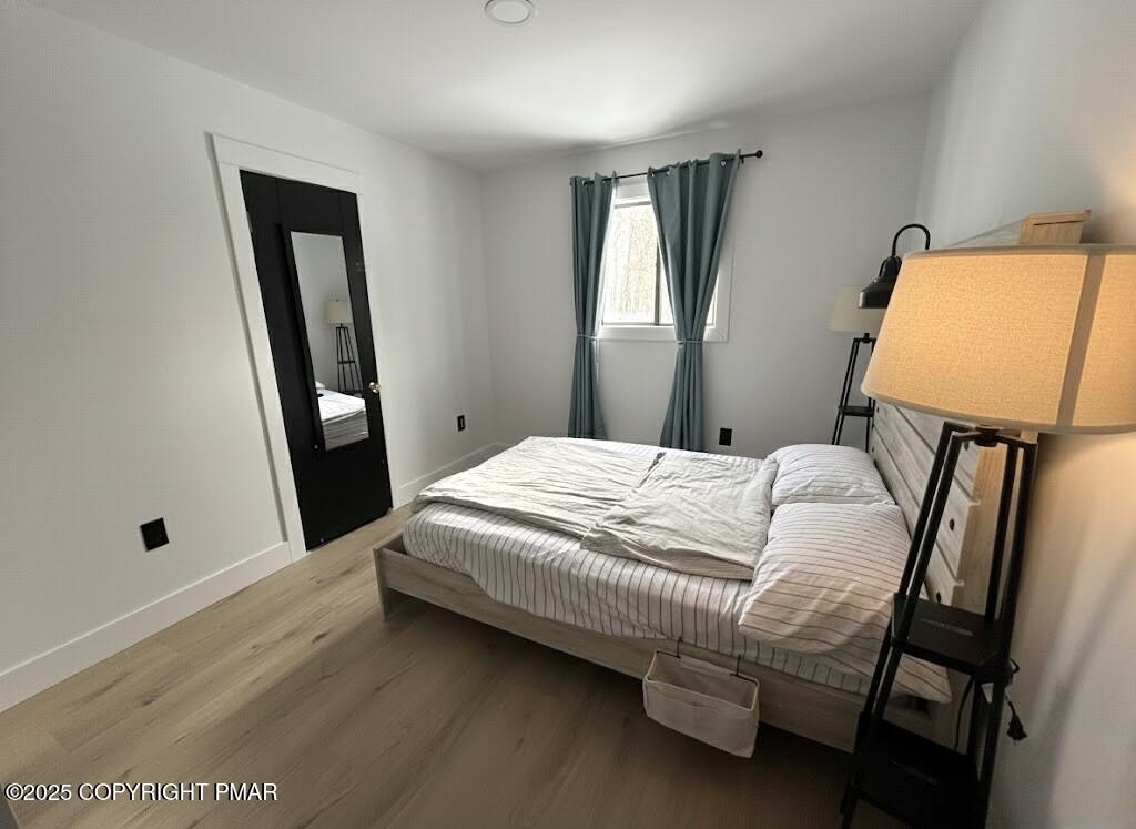 1215 Steele Circle Bushkill, PA 18324 - Photo 7 of 13 a bedroom with a bed and a mirror