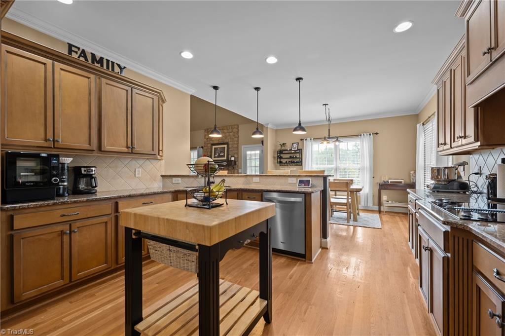 5822 Crutchfield Farm Road Oak Ridge, NC 27310 - Photo 18 of 47 Plenty of cabinet space, flat cooktop, kitchen open to LR and breakfast area