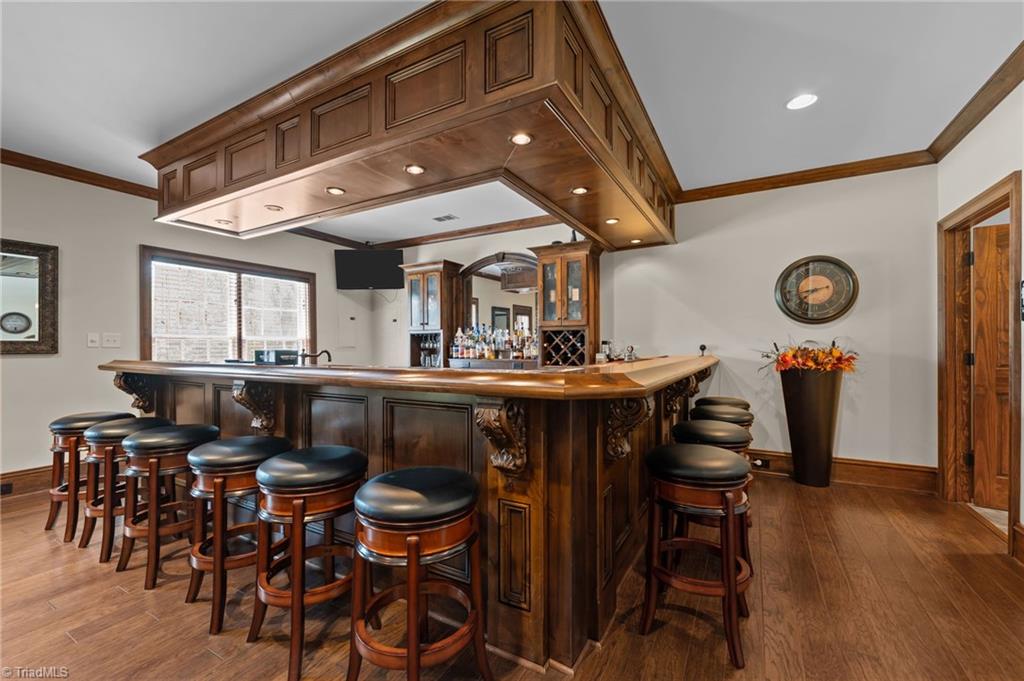 5822 Crutchfield Farm Road Oak Ridge, NC 27310 - Photo 2 of 47 Full bar features wood counters and shelves, dishwasher, pellet ice maker, beverage cooler and mini fridge