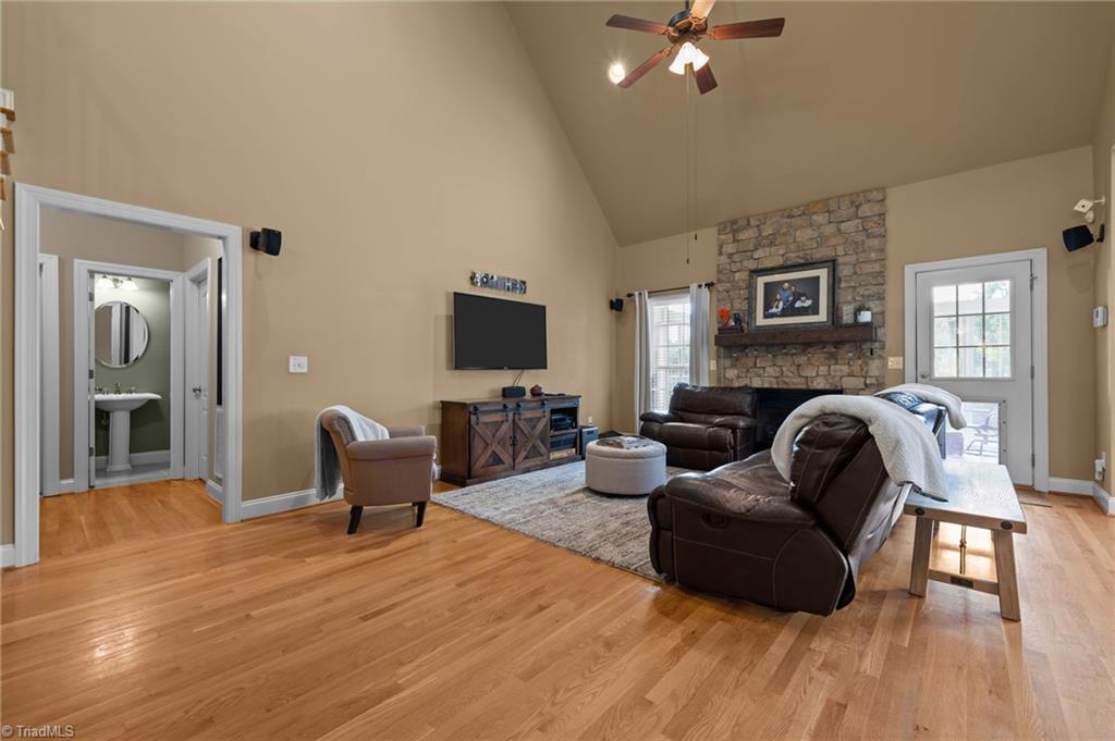 5822 Crutchfield Farm Road Oak Ridge, NC 27310 - Photo 22 of 47 Open concept main level, vaulted ceiling and stone gas log fireplace create a warm and inviting living space