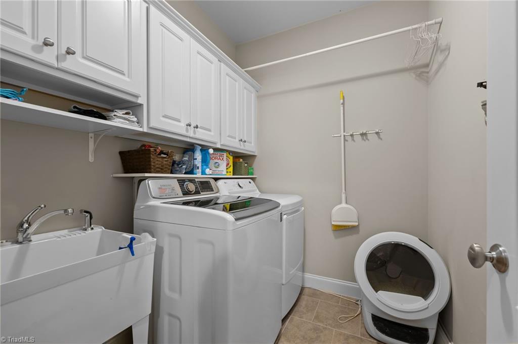5822 Crutchfield Farm Road Oak Ridge, NC 27310 - Photo 25 of 47 Main level separate laundry room with cabinets and sink