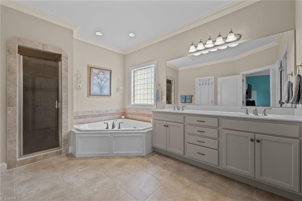 5822 Crutchfield Farm Road Oak Ridge, NC 27310 - Photo 27 of 47 Large primary bathroom with jetted tub and double sinks
