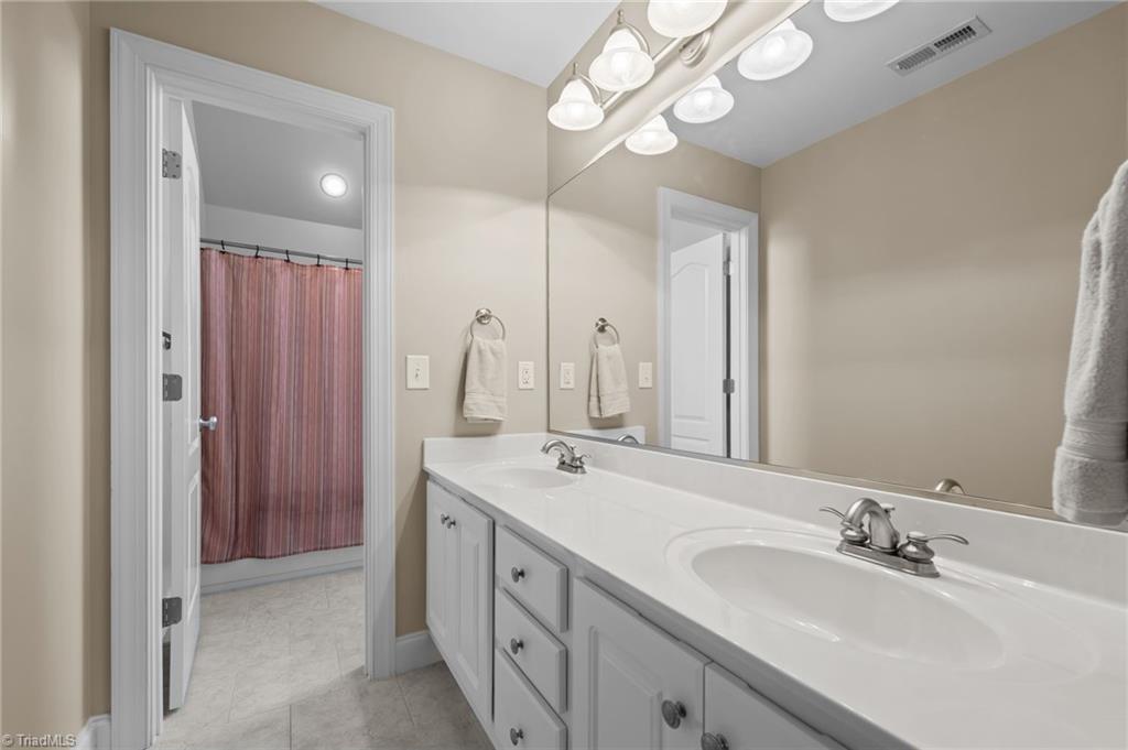 5822 Crutchfield Farm Road Oak Ridge, NC 27310 - Photo 31 of 47 Upstairs hall bathroom with double sinks