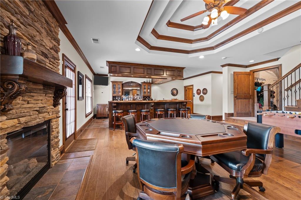 5822 Crutchfield Farm Road Oak Ridge, NC 27310 - Photo 4 of 47 Tray ceilings, stone gas log fireplace. Walk-in storage area