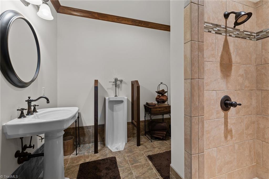 5822 Crutchfield Farm Road Oak Ridge, NC 27310 - Photo 42 of 47 Full bathroom in basement with shower, urinal, industrial hand dryer