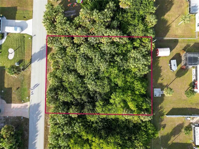 an aerial view of a house with a yard and garden