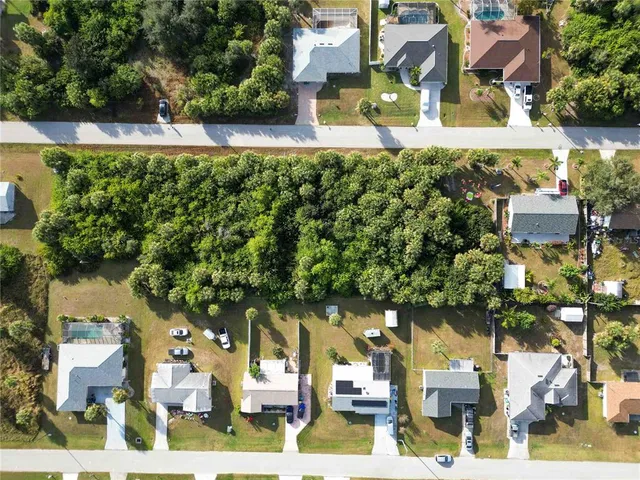 an aerial view of a house with a yard basket ball court and outdoor seating