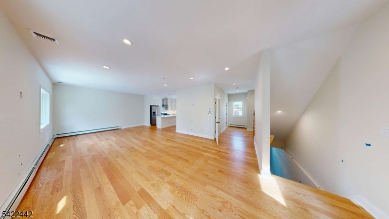 376 5th Avenue Paterson, NJ 07514 - Photo 13 of 20 a view of empty room with wooden floor