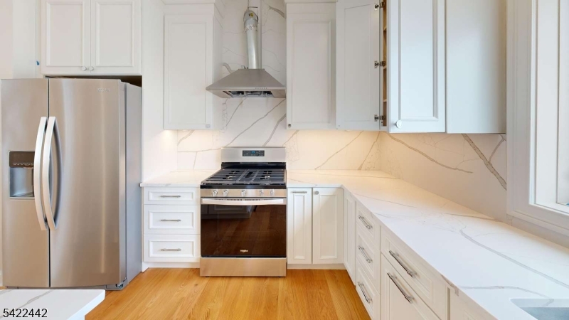 376 5th Avenue Paterson, NJ 07514 - Photo 4 of 20 a kitchen with a stove and a refrigerator
