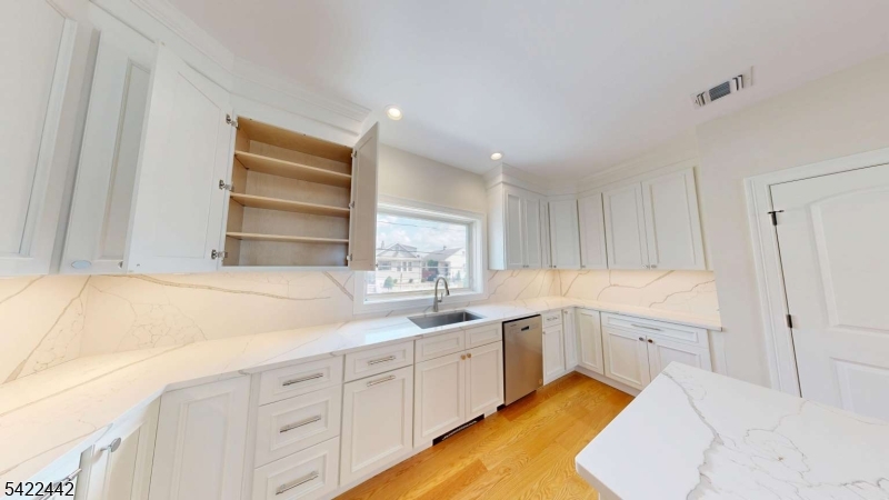 376 5th Avenue Paterson, NJ 07514 - Photo 5 of 20 a kitchen with white cabinets and sink
