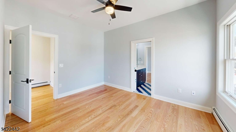 376 5th Avenue Paterson, NJ 07514 - Photo 9 of 20 wooden floor in an empty room with a window