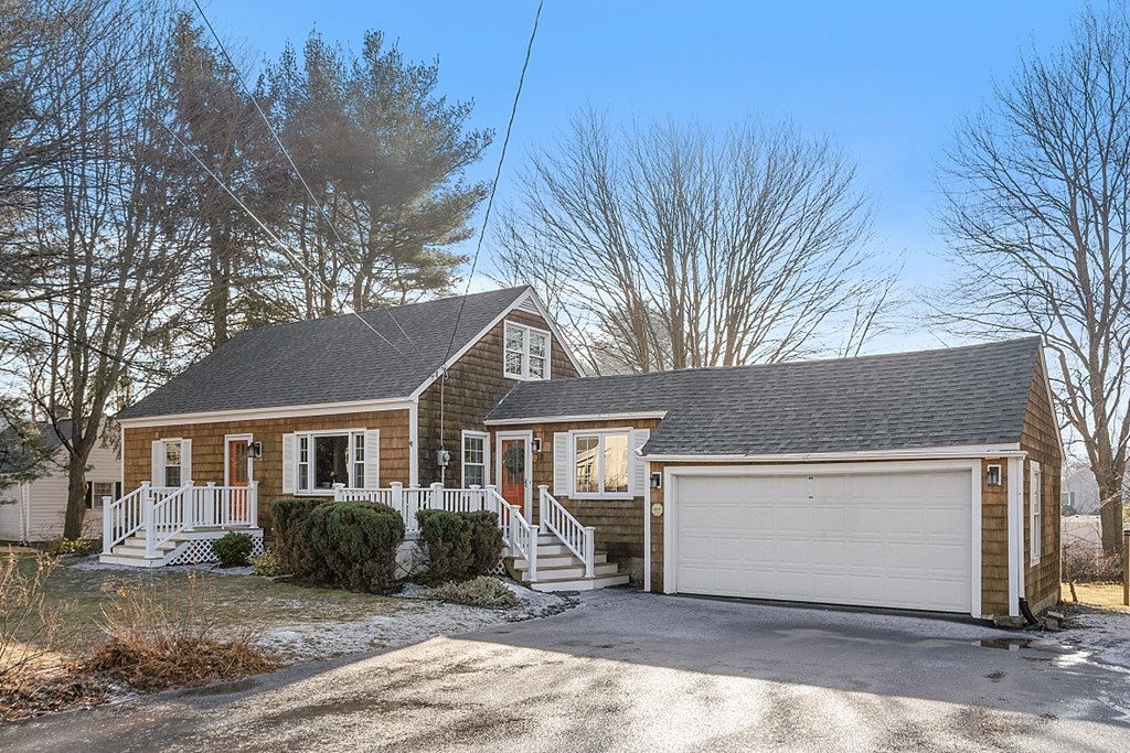 a view of a house with a tree in front of it