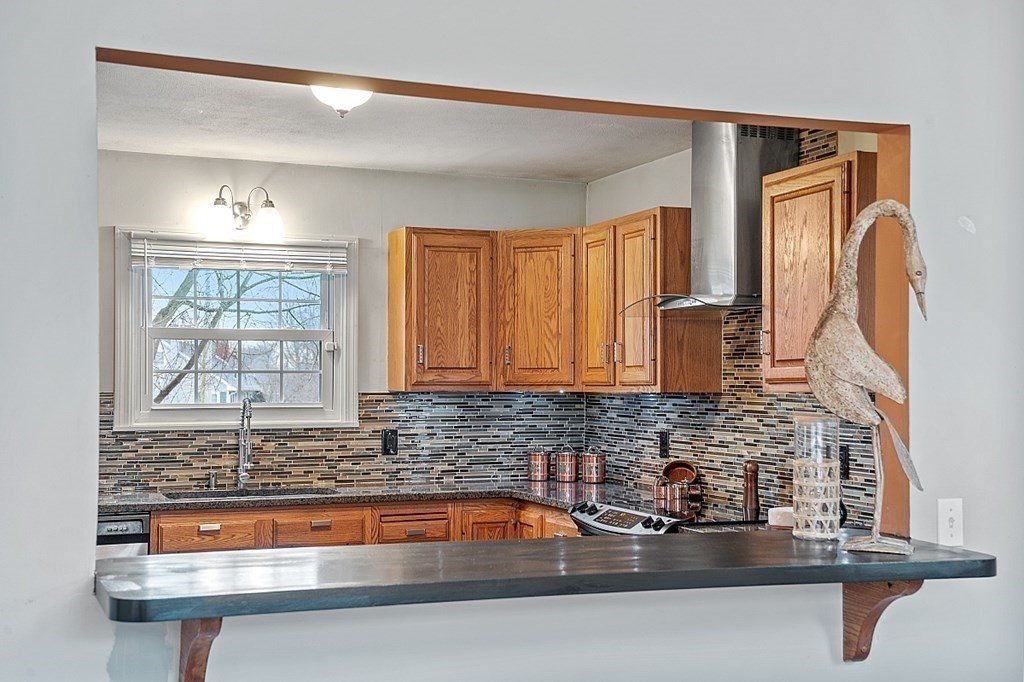 311 High Street Hampton, NH 03842 - Photo 7 of 21 a kitchen with sink a window and cabinets