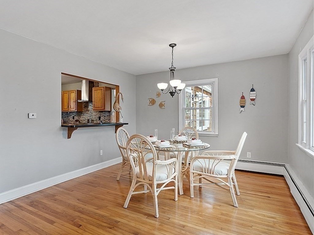 311 High Street Hampton, NH 03842 - Photo 8 of 21 a view of a dining room with furniture wooden floor and chandelier