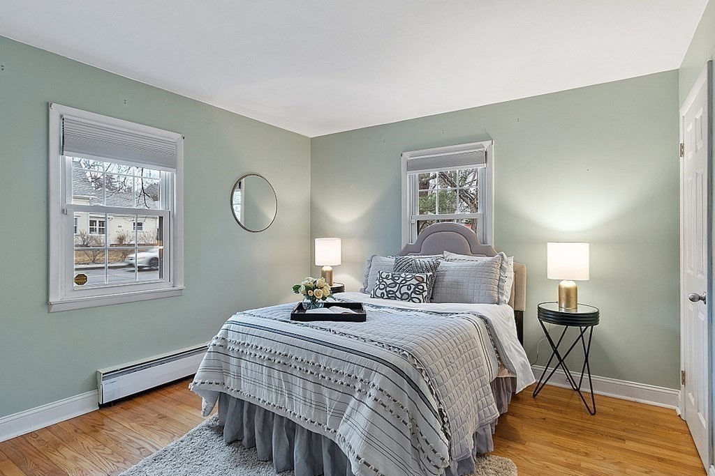311 High Street Hampton, NH 03842 - Photo 9 of 21 a bedroom with a bed and a painting on the wall