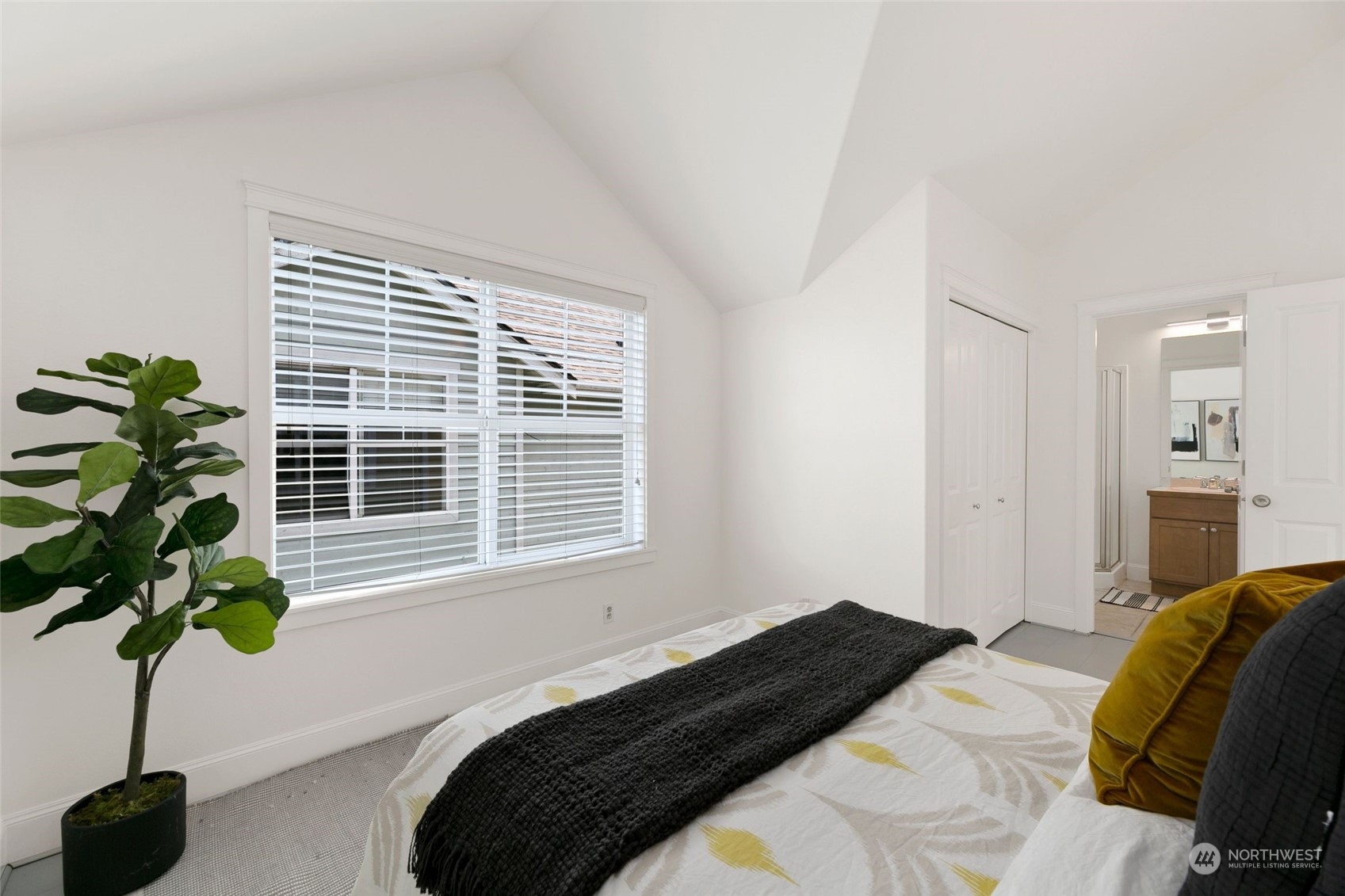 2622 East Union Street Seattle, WA 98122 - Photo 19 of 30 a bedroom with a bed a chandelier and a window