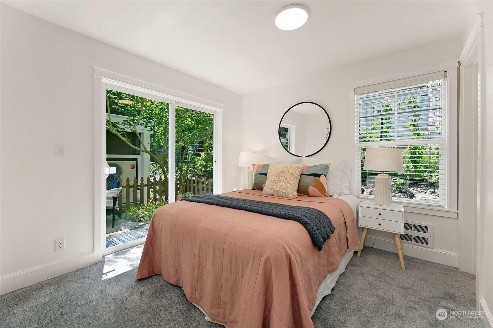 2622 East Union Street Seattle, WA 98122 - Photo 22 of 30 a bedroom with a bed lamp and a large window