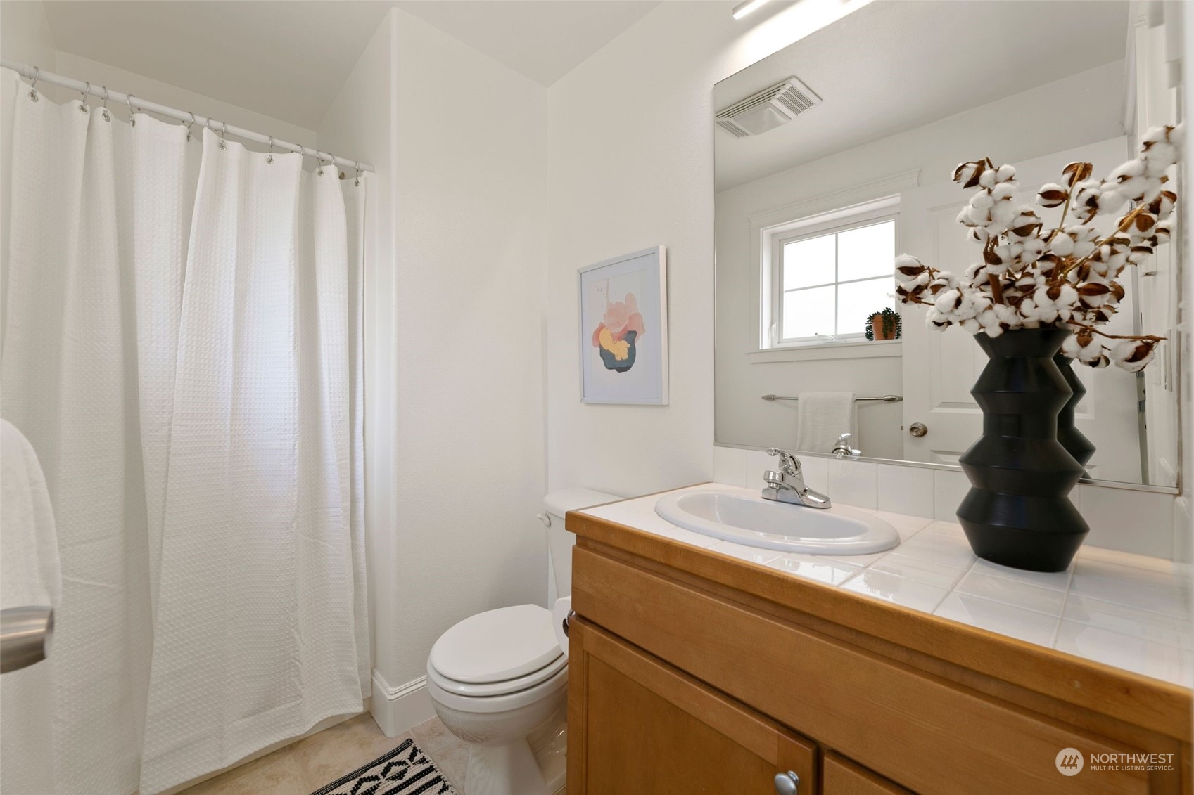 2622 East Union Street Seattle, WA 98122 - Photo 25 of 30 a bathroom with a sink toilet and a mirror