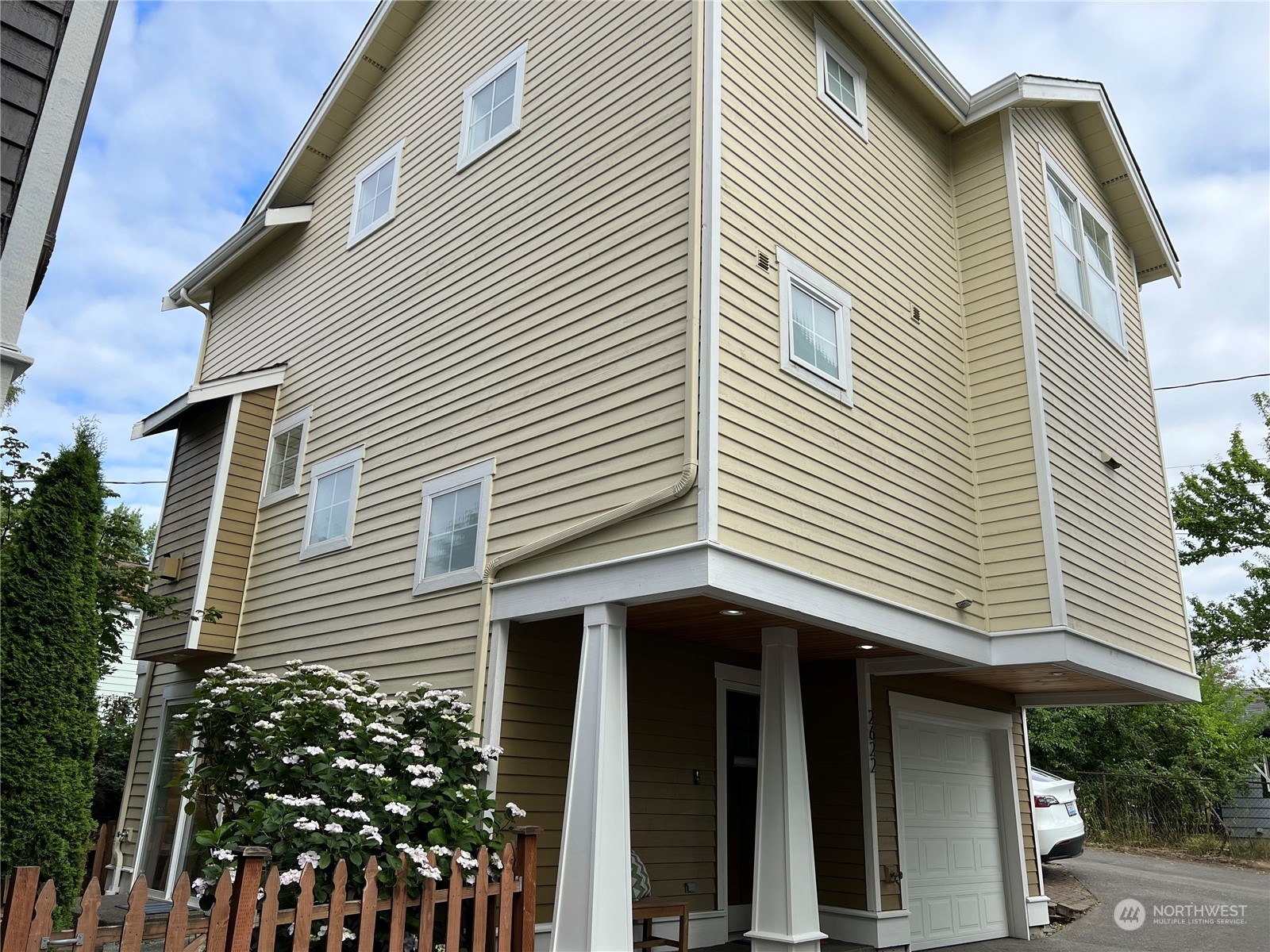 2622 East Union Street Seattle, WA 98122 - Photo 29 of 30 a view of a white house with a door and wooden bench