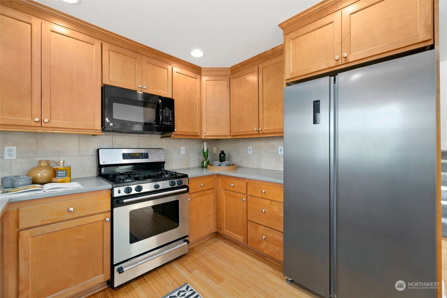 2622 East Union Street Seattle, WA 98122 - Photo 7 of 30 a kitchen with stainless steel appliances granite countertop a stove a refrigerator and a microwave