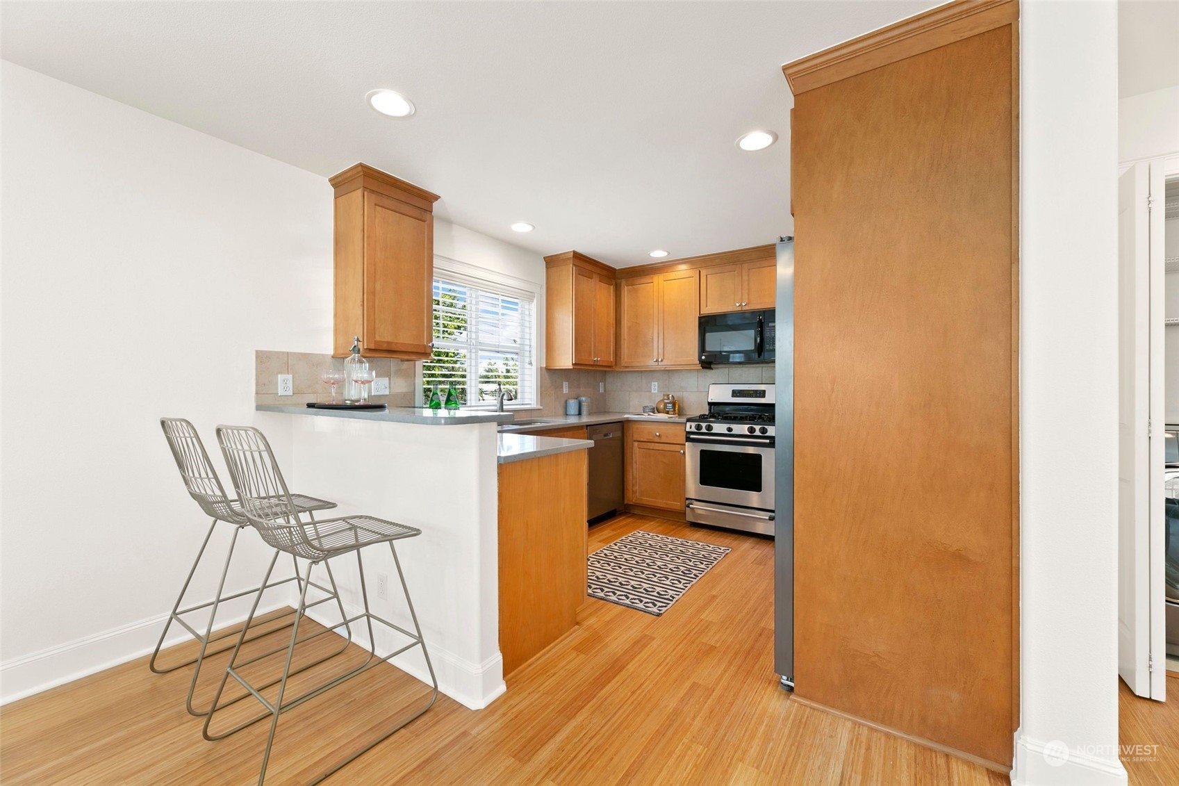 2622 East Union Street Seattle, WA 98122 - Photo 8 of 30 a kitchen with a table chairs refrigerator and cabinets