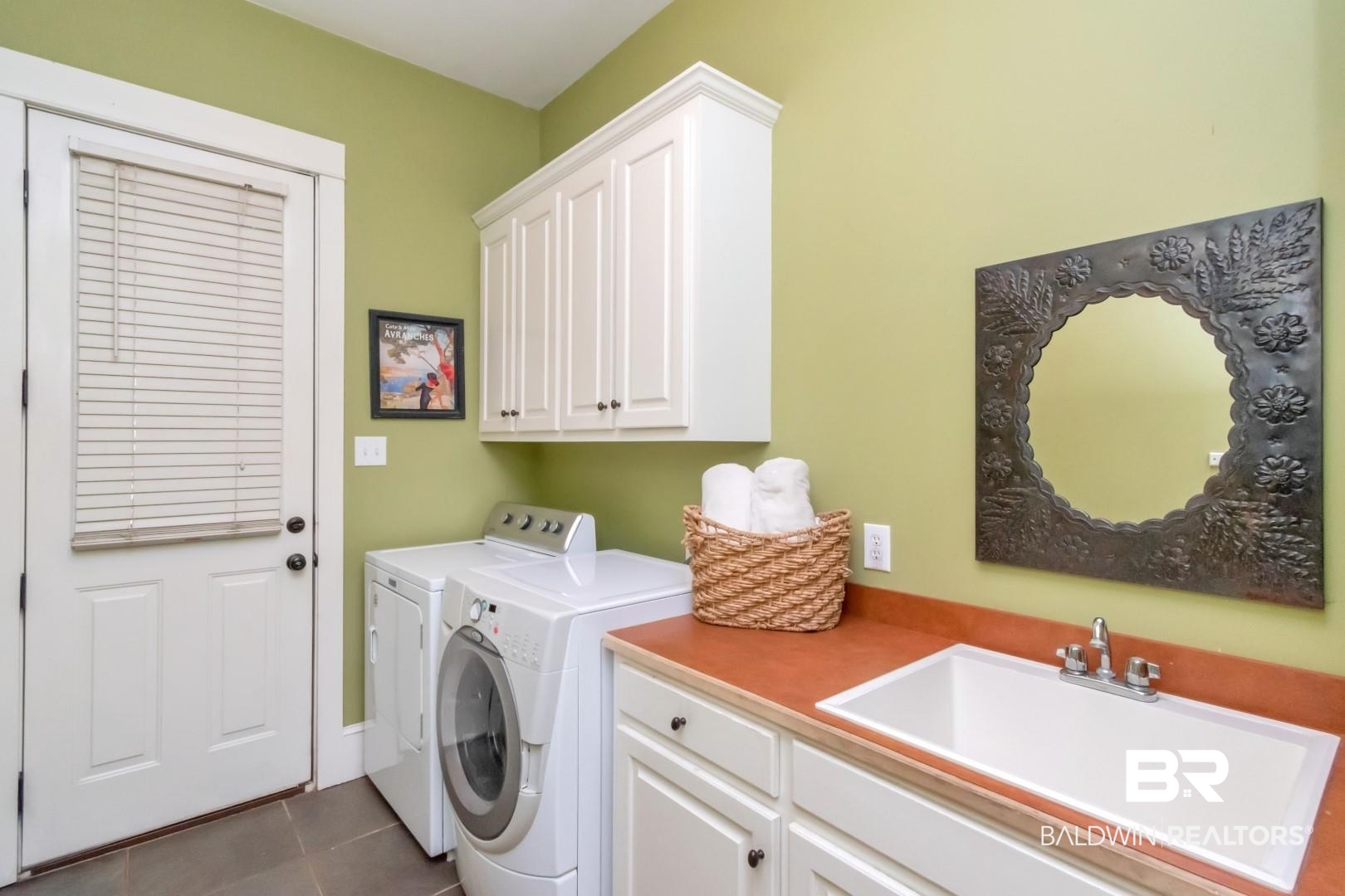 8868 Dawes Lake Road South Mobile, AL 36619 - Photo 32 of 35 Washroom featuring sink, tile patterned flooring, separate washer and dryer, and cabinets